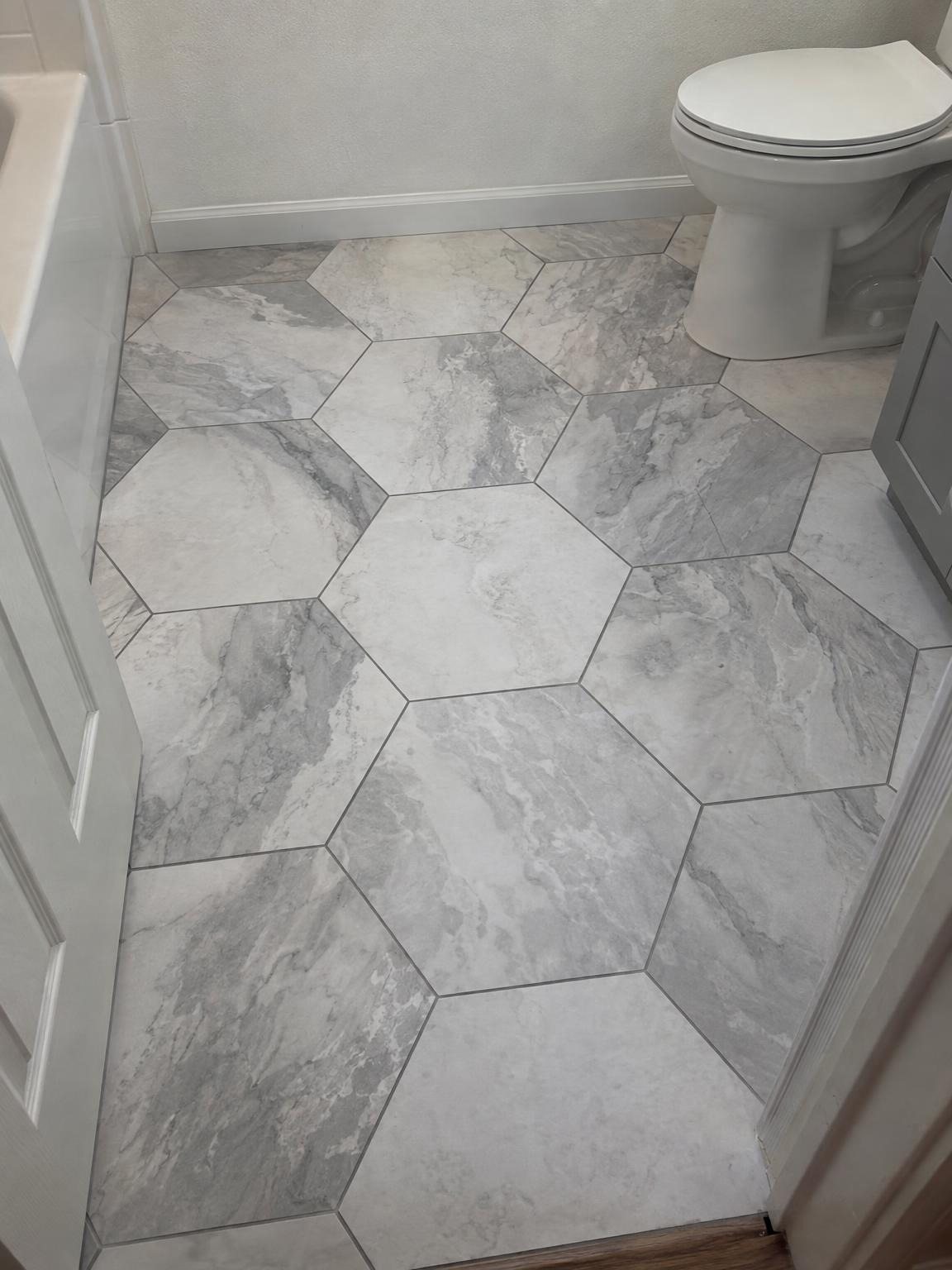 Bathroom floor in large grey and white hexagon tile