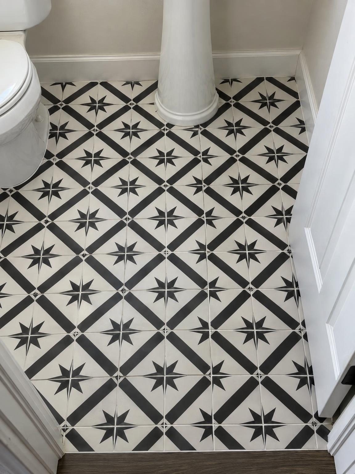 Black and white patterned floor tile in a small room