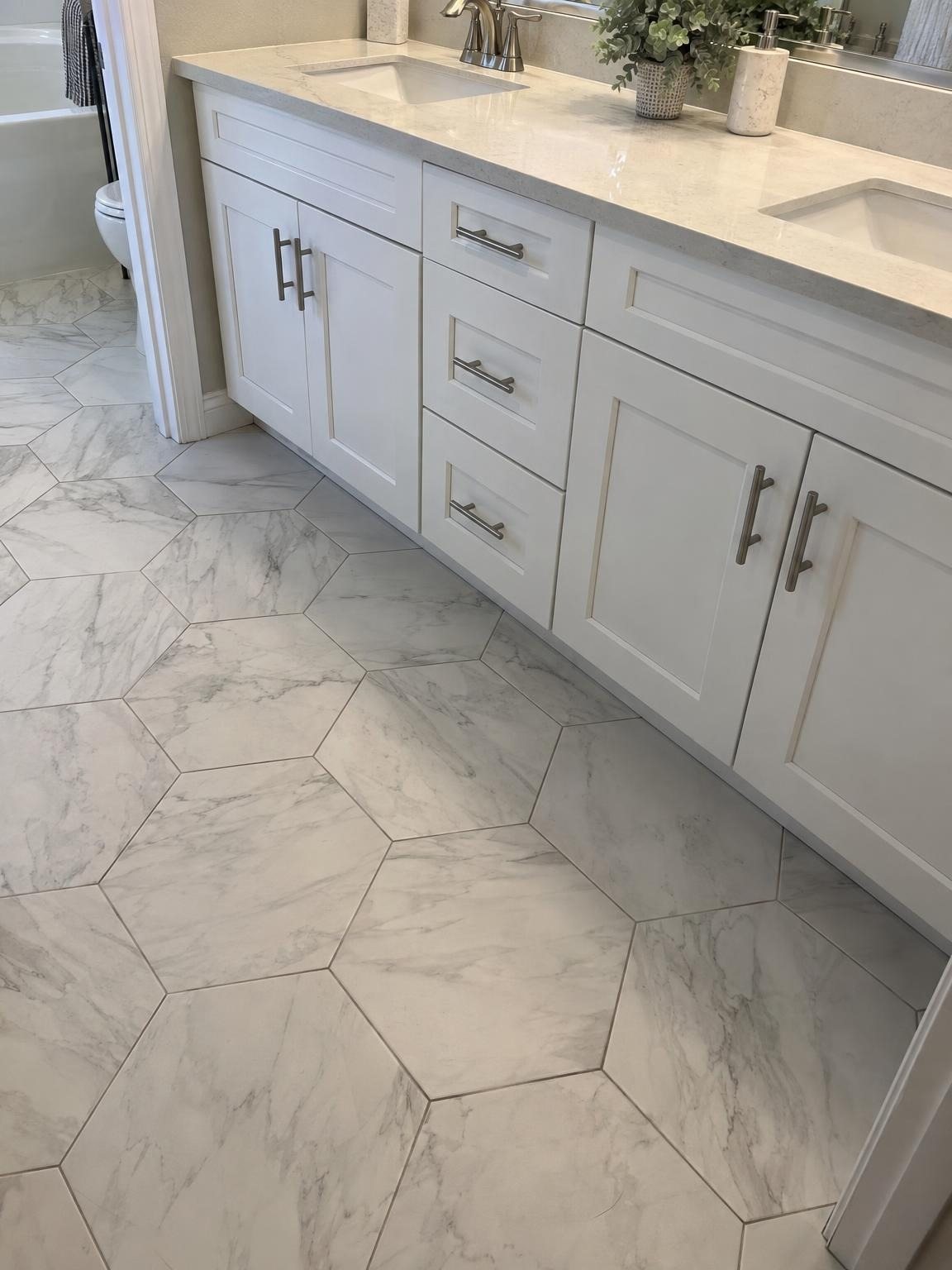 Hexagon tile running under a bathroom vanity