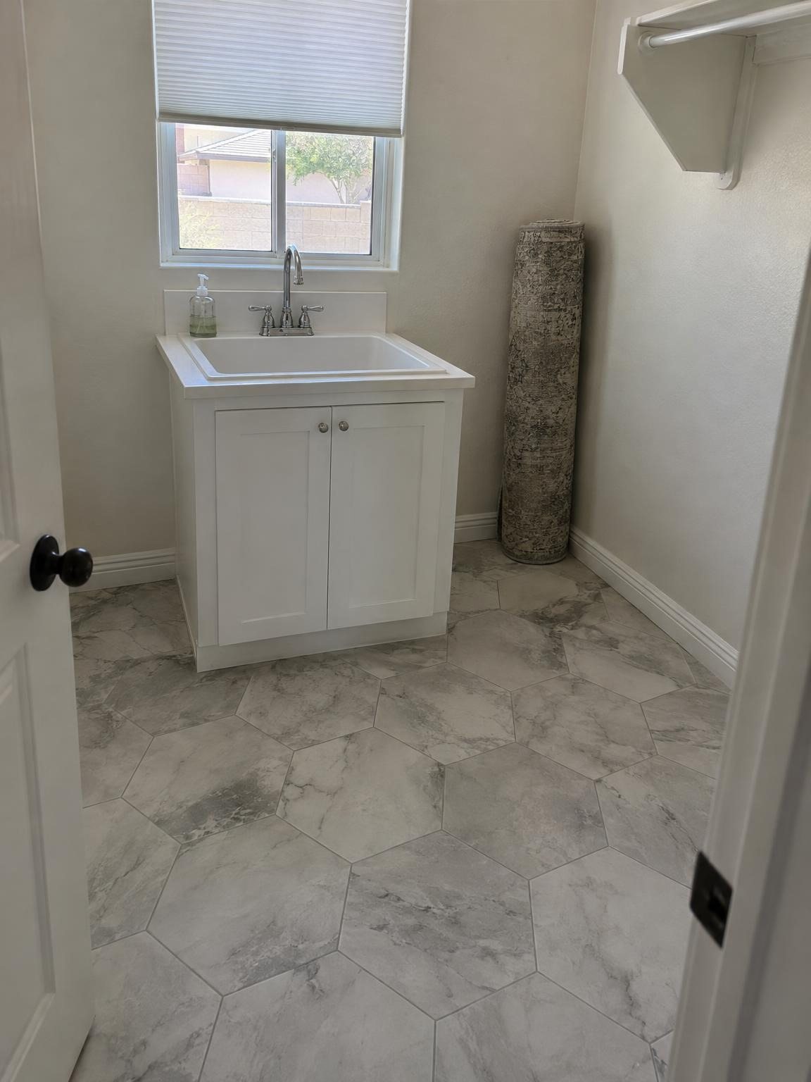 Hexagon tile laundry floor by the sink
