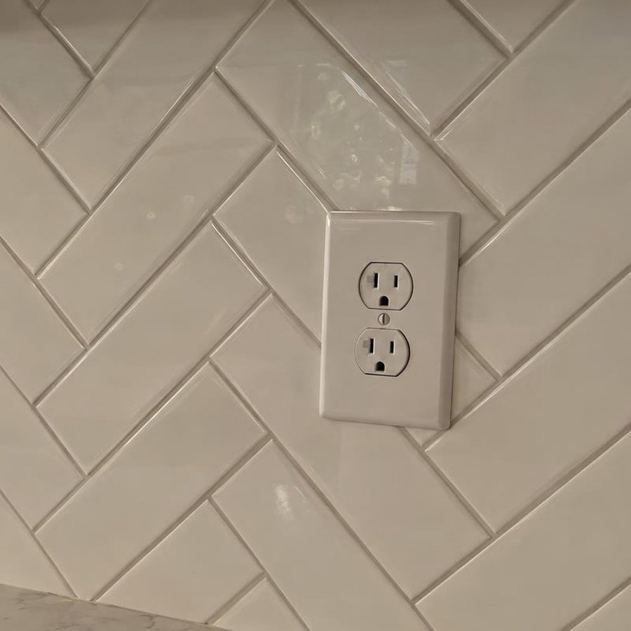 Close-up of a white herringbone backsplash