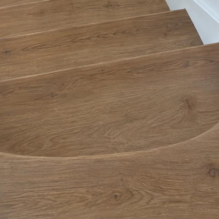 Close-up of curved stair treads clad in wood-look planks