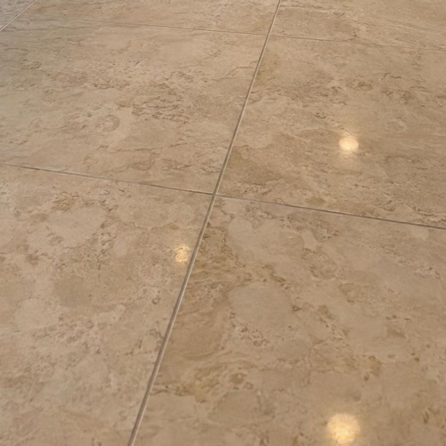 Close-up of a polished travertine tile floor